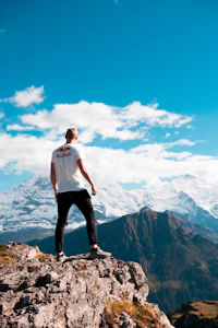A person standing at a cliff edge, poised